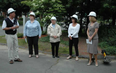 Group Speaking in Hard Hats for Ground Breaking Ceremony